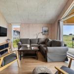 Living room with sofa, TV, and view of the terrace.