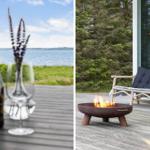 Tisch mit Wein und Blumen am Wasser. Feuerkorb und Sitzgelegenheit auf Terrasse.