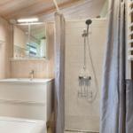 Badezimmer mit Dusche, Waschbecken und Heizung