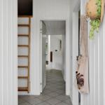 Hallway with wooden ladder and hanging items