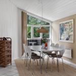 Dining room with table, chairs, and window to the outside.