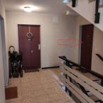 Flur mit Tür, Rollstühlen und Treppenhaus