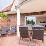 Terrace with seating group and sun loungers. Entrance to living room.