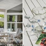 Terrasse mit weißem Tisch und Stühlen, Glasgäste und Karaffe auf Tisch.