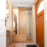 Eingangsbereich mit Garderobe, Spiegel und Haken für Jacken.
