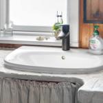 Waschbecken mit Mosaikarbeitsplatte, Fenster und Spülmittelflasche