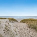 Sandweg zwischen Dünen führt zum Strand und Meer.