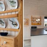 Küche mit Holzwand und Kücheninsel. Wandregal mit dekorativen Tellern.