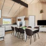 Küche mit Essbereich, TV und Terrasse. Holzwände und -boden.