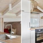 Küche mit Spüle, Kaffeemaschine und Ofen unter Holzdecke.