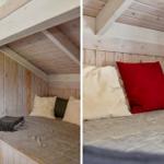 Ein Bett unter einem Holzdach mit Kissen und einer Decke.