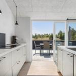Moderne Küche mit Blick auf Terrasse und Garten.