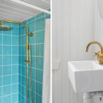 Bath with blue tiles and gold shower system. Toilet and sink with gold faucet.