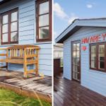 Blue wooden house with bench and sign HAV ARE YOU?