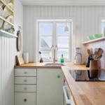 Kitchen with wooden surfaces, sea view window, and kitchen appliances.