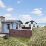 Blue house with wooden terrace and sea view