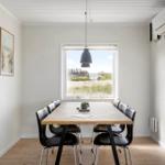 Dining room with table, chairs, and view of green fields