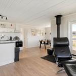 Kitchen, dining area, and seating with view to the terrace.