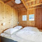 Bedroom with wooden walls, bed and ladder