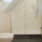 Badezimmer mit Dusche, Toilette und Heizung