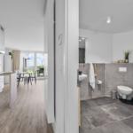Küche mit Essbereich und Badezimmer mit Toilette und Waschbecken