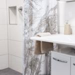 Bathroom with shower curtain, sink, and towel