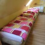 Drei Schlafplätze in einem Dachzimmer mit Holzboden und Dachschräge.