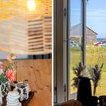 Tisch mit Blumen und Laterne, Blick auf Hafen und Grasland