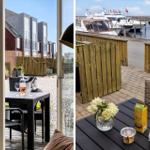 Terrasse mit Tisch und Stühlen, Blick auf Häuser und Hafen mit Booten.
