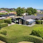 Modern villa with large garden, terrace, and sea view.