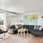 Living room with gray sofa, wooden table, and world map on the wall.