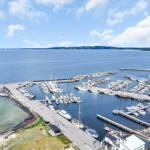 Marina with boats and piers on a sunny day.
