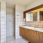 Bathroom with two sinks, mirror cabinet, and shower