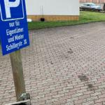 Parkplatz für Eigentümer und Mieter an Schillerstr. 30 mit P-Schild und gepflastertem Boden.
