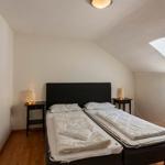 Schlafzimmer mit Dachschräge, zwei Matratzen und Fenster