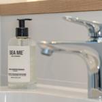 Hand disinfection gel and faucet on sink