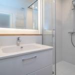 Bathroom with shower, sink, and mirror