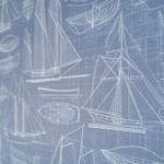 Wall with technical drawings of ships and boats in white on blue background.
