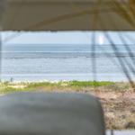 Sea view from window overlooking beach and green areas