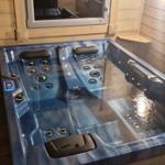 Ein blauer Whirlpool mit mehreren Massage Düsen und einem digitalen Steuerfeld.