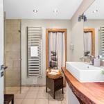 Bathroom with shower, sink, and heater