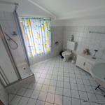 Badezimmer mit Dusche, Toilette und Waschbecken