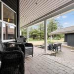 Terrasse mit Sitzgruppe und Grill, Blick auf Garten und Nebengebäude.