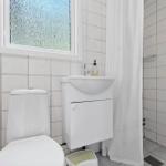 Badezimmer mit Toilette, Waschbecken und Dusche mit Duschvorhang.