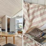 Wohnzimmer mit Holzdecke und Tisch. Bett mit gestreifter Decke und offenem Buch.