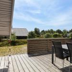 Terrasse mit Tisch und Stühlen, Blick auf Grünflächen und Häuser
