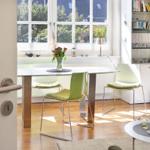Dining room with green chairs, table, and bookshelf. Window with view of garden.