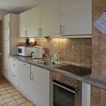 Kitchen with countertop, sink, stove, and microwave.