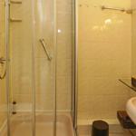 Bathroom with shower, sink, and mirror