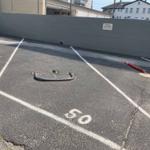 Parking lot with marked spaces and metal object